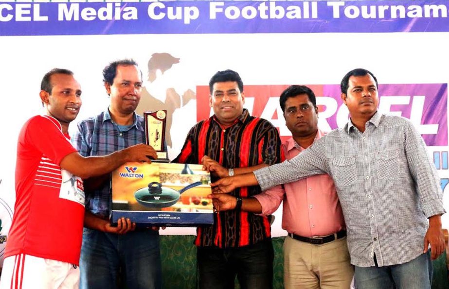 Operative Director and Head of Sports & Welfare Department of Walton Group FM Iqbal Bin Anwar Dawn (third from the left) handing over the award of the player of the match of the Marcel-BSJC Media Cup Football Tournament at the Shaheed (Captain) M Mansur A