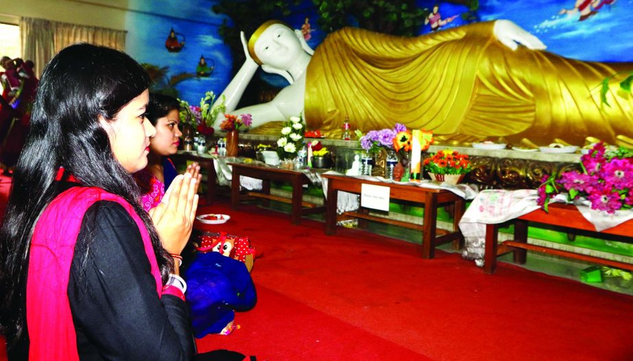 To mark the Buddha Purnima, the biggest religious festival of the Buddhist community, devotees on Wednesday offering prayers before the statue of Lord Buddha. This photo was taken from a Buddhist temple at Basabo in the city.