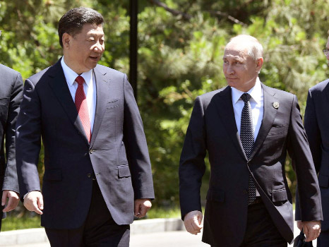 Russian President Vladimir Putin, right, and Chinese President Xi Jinping, left, walk prior to the opening ceremony of the Belt and Road Forum in Beijing on Sunday.