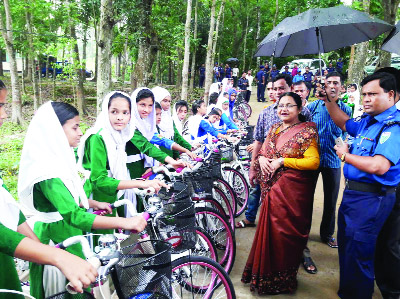 KULAURA (Moulvibazar): Dr Nazmanara Khanam, Divisional Commissioner, Sylhet giving bicycle among the girl students at Barolekha Upazila recently.