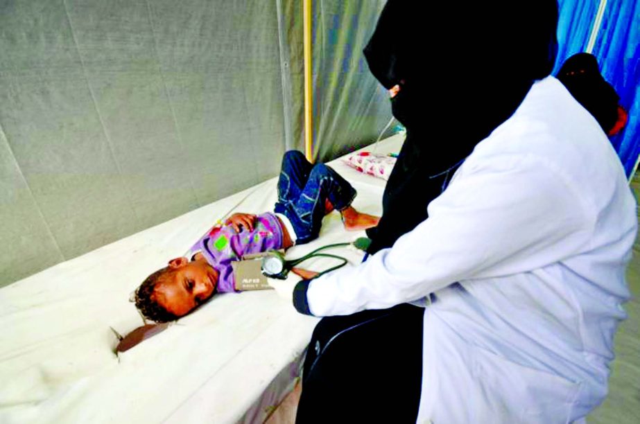 A nurse attends to a boy infected with cholera at a hospital in the Red Sea port city of Hodeidah, Yemen.