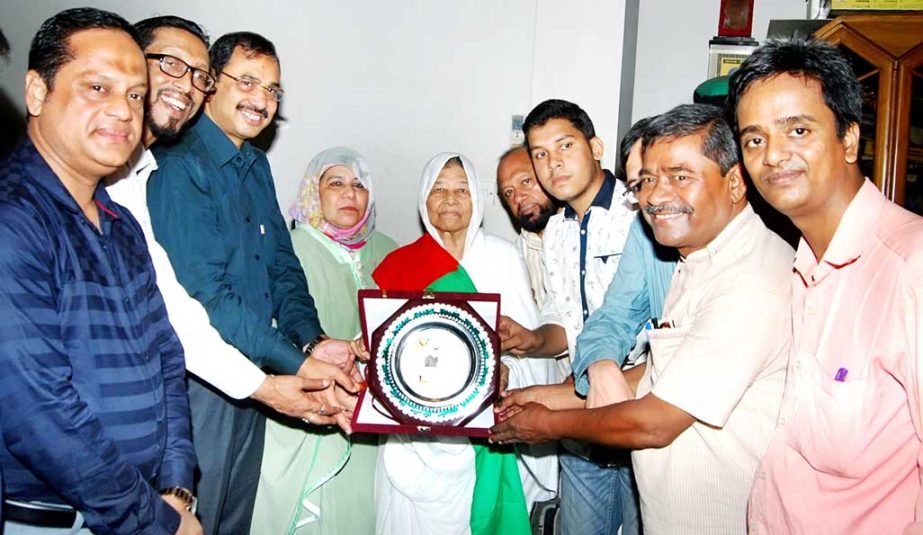 General Secretary of Bangabandhu and National Four Leaders Memorial Council Abdur Rahim handing over the award to 'Ratnagarbha Ma' to Fatima Johra Begum , mother CCC Mayor at the residence of mayor marking the International Mother's Day on Sunday.