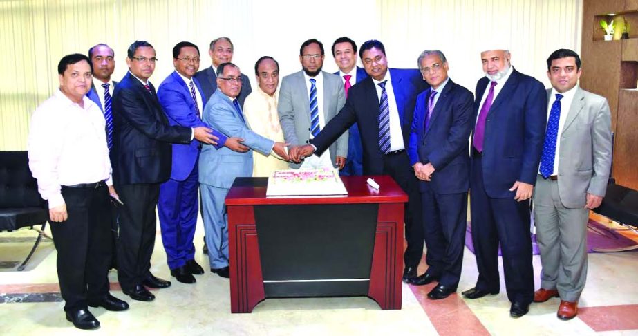 Abdus Salam, Chairman and Khairul Alam Chaklader, Director of NCC Bank Limited, celebrating its 24th founding anniversary at the bank's head office in the city on Wednesday. Mosleh Uddin Ahmed, Managing Director of the bank was also present.