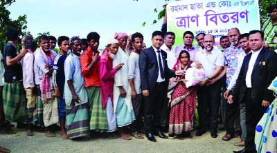 SYLHET: Assistance Governor Rotarian PP Md Ferdous Alam distributing relief among the flood -hit people at Santal area of Sunamganj recently.