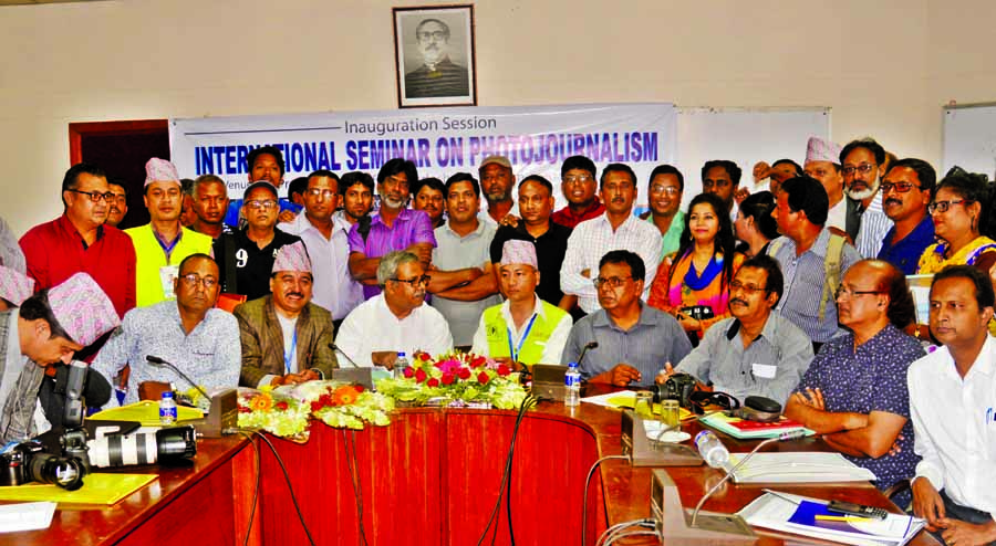 A ten-member delegation of Nepal and members of Bangladesh Photo Journalists Association pose for a photo session at a seminar organised jointly in the auditorium of the Press Institute of Bangladesh in the city on Thursday.