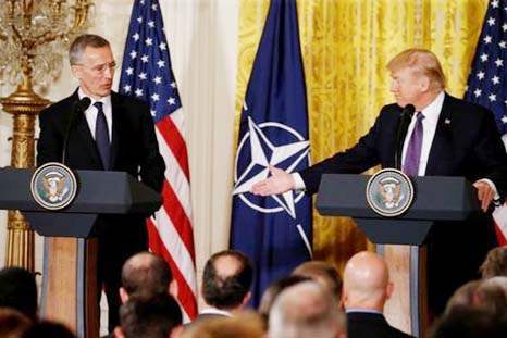 U.S. President Donald Trump Â® and NATO Secretary General Jens Stoltenberg hold a joint news conference in the East Room at the White House in Washington.