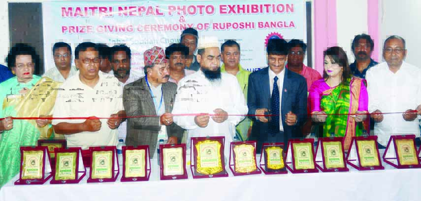 Second Secretary of the Embassy of Nepal in Dhaka Dilli Prasad Acharya inaugurating Maitri Nepal Photo Exhibition and Prize Giving Ceremony of Ruposhi Bangla by cutting ribbon in the auditorium of Bangladesh Photo Journalists Association in the city on Sa