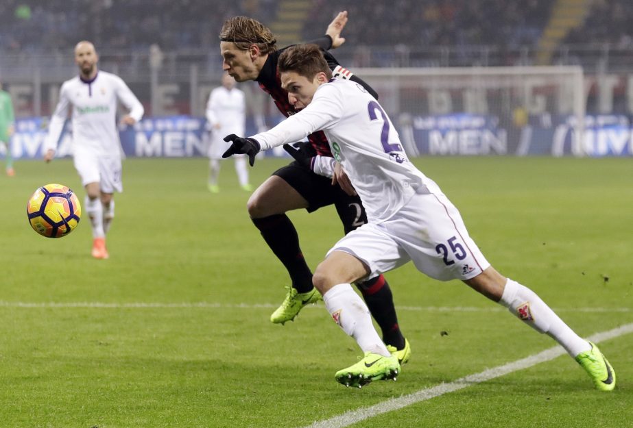 In this Feb. 19, 2017 file photo, Fiorentina's Federico Chiesa (right) and AC Milan's Ignazio Abate go for the ball during a Serie A soccer match at the San Siro stadium in Milan, Italy. Italy's hopes may rest on the shoulders of Federico Chiesa of Fio