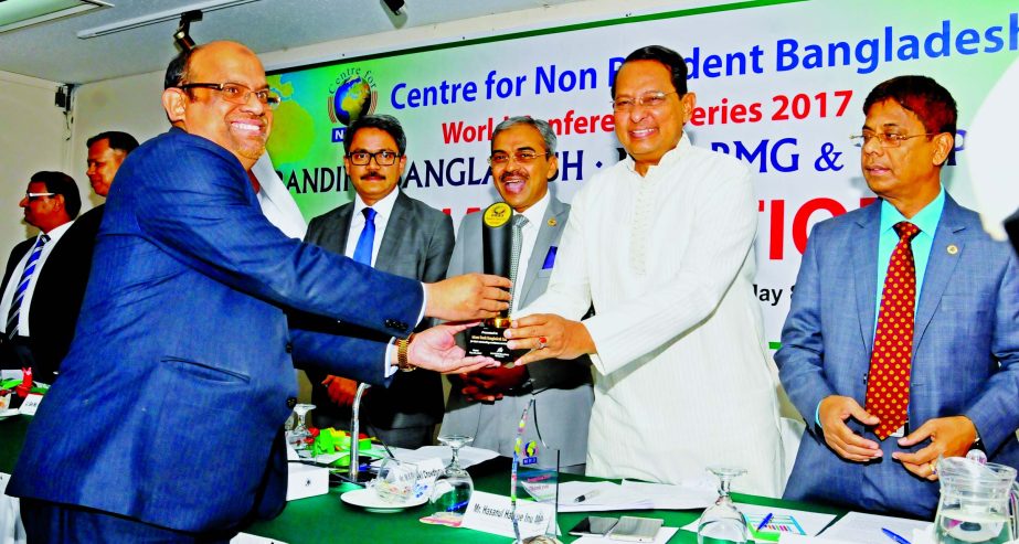 Md Shafiqur Rahman, Executive Vice President and Head of International Bankining of Islami Bank Bangladesh Limited receiving a gold medal award from Information Minister Hasanul Haq Inu, for its outstanding contribution to the foreign remittance services