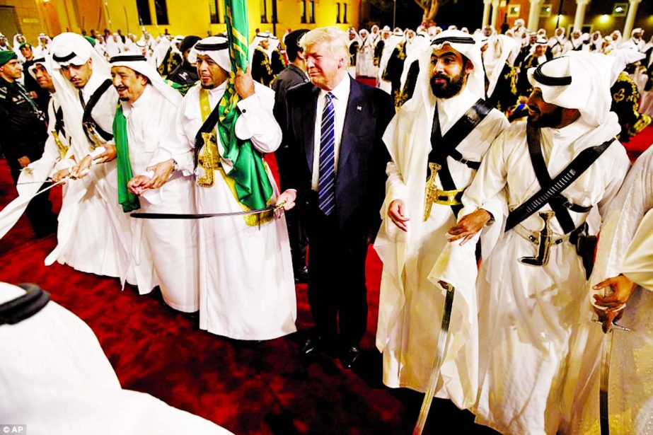 Trump gripped the sword as he stood beside traditional dancers during a welcome ceremony at Murabba Palace.
