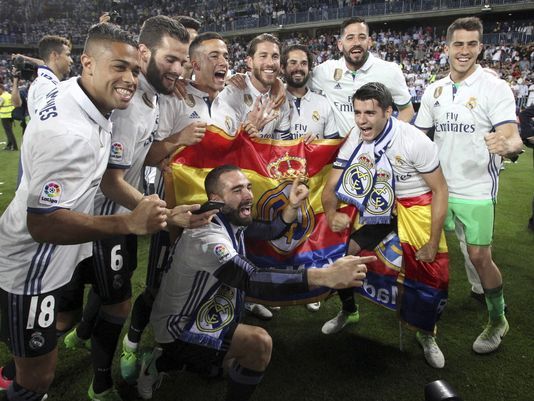 Real Madrid players celebrate winning the La Liga title for the first time in five years.