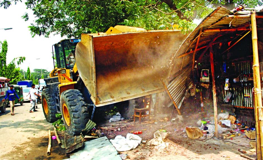 Illegal structures on both sides of the road at Sher-e-Bangla Nagar was bulldozed as part of the regular eviction drive by the Dhaka North City Corporation on Monday.