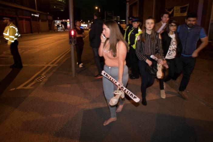 Concert goers react after fleeing the Manchester Arena in northern England where U.S. singer Ariana Grande had been performing in Manchester, Britain, May 22, 2017. REUTERSJon Super