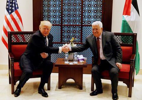 US President Donald Trump shakes hands with Palestinian President Mahmoud Abbas during their meeting at the presidential headquarters in the West Bank town of Bethlehem on Tuesday.