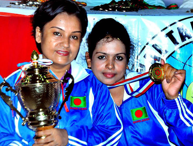 Members of the Walton Taekwondo team, the winners of the Women's Division of the Walton 12th Dhaka ITF Taekwondo Championship pose for a photo session at the gymnasium of National Sports Council on Tuesday.