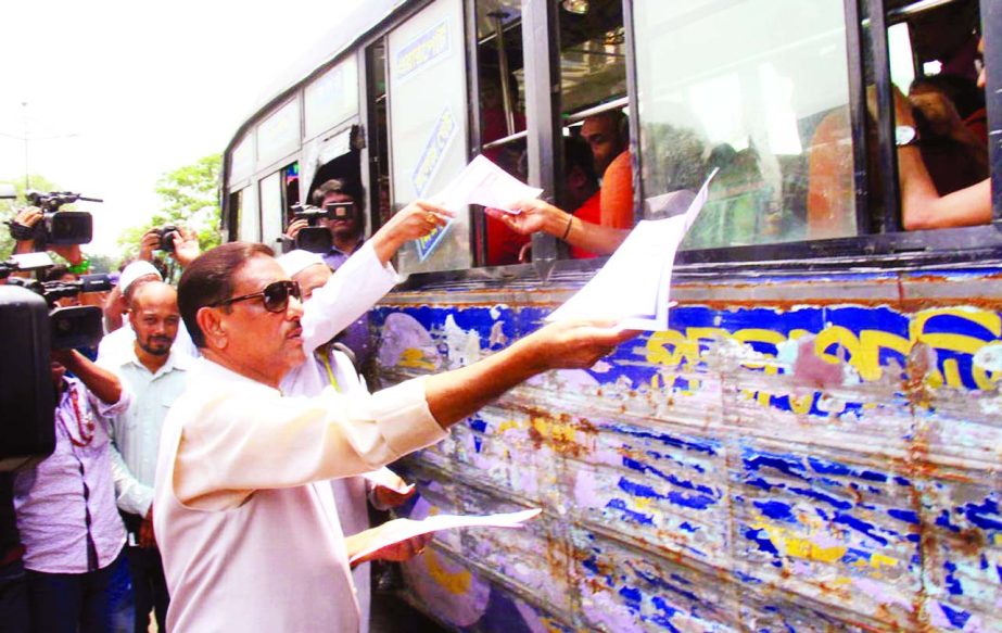 Road Transport and Bridges Minister Obaidul Quader distributing leaflets while visiting the ongoing mobile court activities against rough driving of vehicles at city's Airport Road on Tuesday.