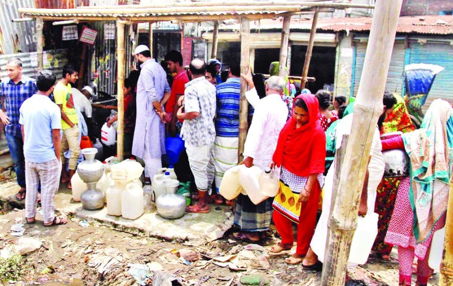 Residents of Dholaipar area in the city jostle to collect water from a WASA pump on Wednesday. Water crisis has turned acute in the capital making lives of city dwellers miserable due to frequent load-shedding.