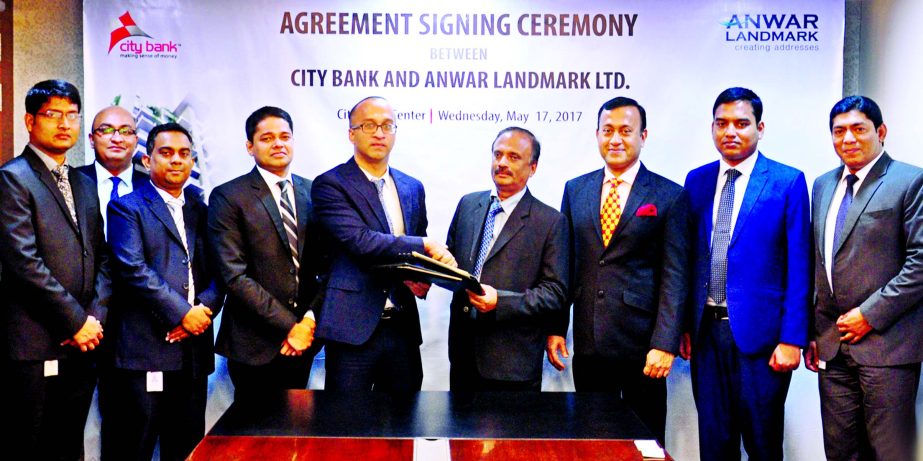 Mashrur Arefin, Additional Managing Director of City Bank Ltd. and Engr. Jahangir Alam Patwary, Managing Director of Anwar Landmark Ltd. exchanging an agreement signing documents at the bank's head office in the city recently. Under the deal, customers o