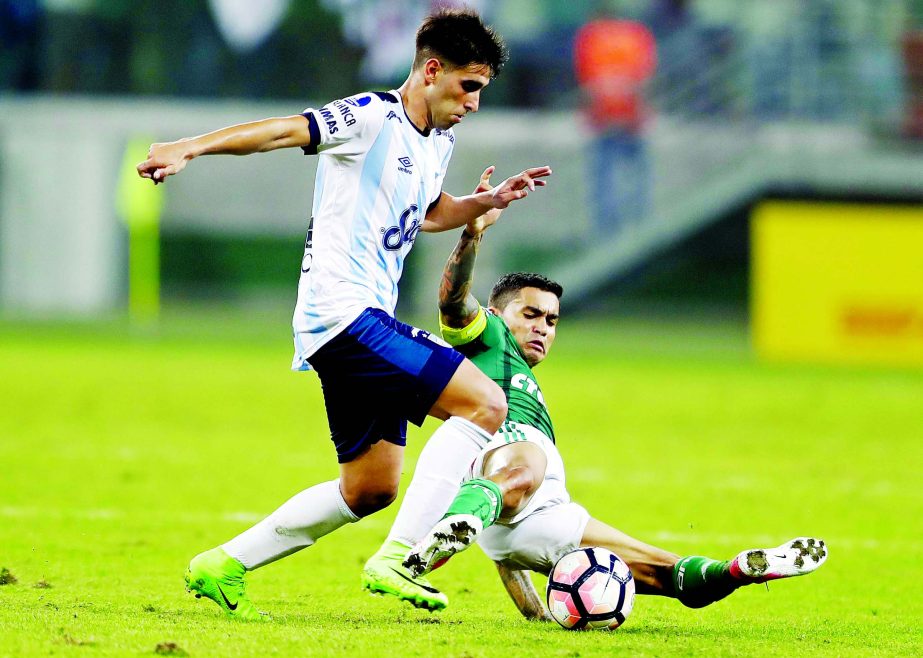 Dudu of Brazil's Palmeiras (right) fights for the ball with Leonel Di Placido of Argentina's Atletico Tucuman, during a Copa Libertadores soccer match in Sao Paulo, Brazil on Wednesday.
