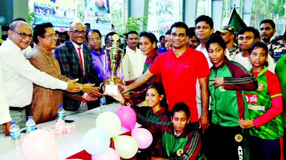 Members of Bangladesh Ansar team, the champions of the Women's Division of the Sheikh Russel 12th National Wushu Championship with the guests and the officials of Bangladesh Wushu Association pose for photograph at the Sheikh Russel Roller Skating Compl
