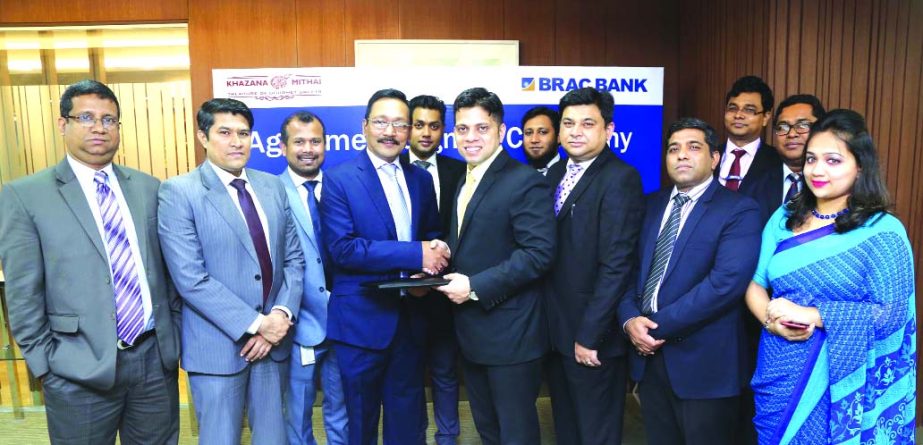 Sadequl Kabir, Managing Director of Khazana Mithai Ltd. and Sheikh Mohammad Ashfaque, Head of Corporate Branches of BRAC Bank Limited, exchanging MoU signing documents at the bankâ€™s head office in the city recently. Under the deal, Premium and Sign