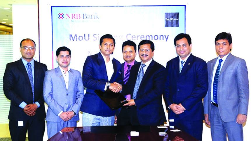Md Mehmood Husain, Managing Director of NRB Bank Limited and Md Al-Amin, Director (Sales) of Hotel Westin Dhaka, exchanging an agreement signing documents at the bank's corporate head office in the city on Thursday. Under the deal, NRB Bank Credit Cardho