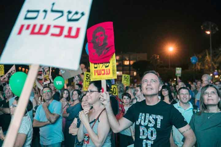 Israeli left-wing supporters in Tel Aviv's Rabin Square demonstrate against 50 years of occupation of Palestinian land on Sunday.