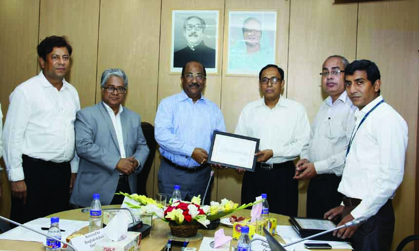 Md. Abul Hossain, Deputy Managing Director of Bangladesh Krishi Bank receiving 'Appreciation Letter' from SK Sur Chowdhury, Bangladesh Bankâ€™s (BB) Deputy Governor at BB's conference hall recently. High officials of respective organizations were