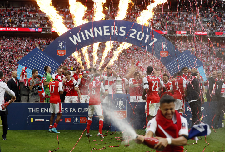 Arsenal players celebrate with the trophy after winning the English FA Cup final soccer match between Arsenal and Chelsea at Wembley stadium in London on Saturday. Arsenal won 2-1.