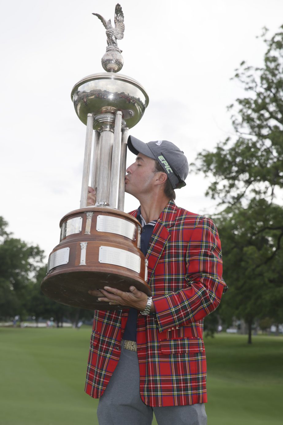 Kevin Kisner kisses the championship trophy after winning the Dean & DeLuca Invitational golf tournament at Colonial Country Club in Fort Worth, Texas, Sunday.