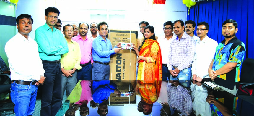 Walton Group handing over a fridge to the leaders of Dhaka Sub-Editors Council (DSEC) on Monday as the first prize of raffle draw in the family day of the organisation held recently. Md Humayun Kabir, Executive Director (PR & Media), Enayet Ferdous, Medi