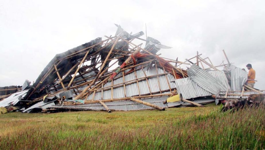 Houses are damaged at Potenga coastal area by the Cyclone Mora on Tuesday.