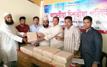 Moulana Mohammad Siraj Uddin distributing copes of holy Quran on the occasion of Ramzan organized by Hathazari Frahadadab Kaderia Chisti Parishad recently.