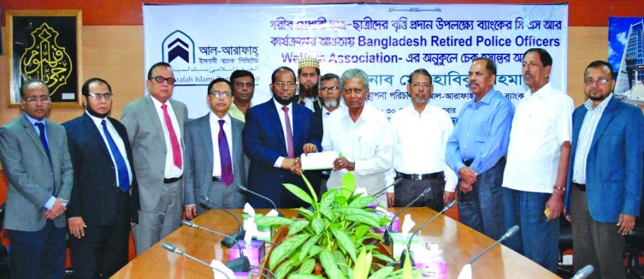 Md Habibur Rahman, Managing Director of Al-Arafah Islami Bank Limited, handed over a cheque of Tk. 5 lakh for giving scholarships to poor and meritorious students to M Shahidul Islam Chowdhury, former Inspector General of Police and President of Banglades