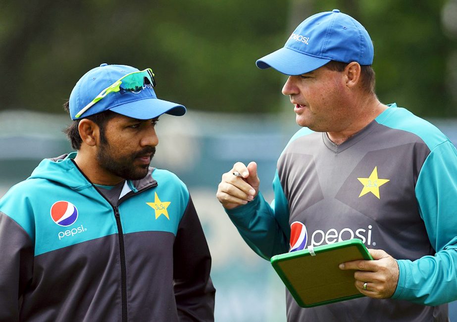 Pakistan's coach Mickey Arthur (R) talks with Pakistan's Sarfraz Ahmed (L) during a nets practice session at Edgbaston cricket ground in Birmingham, central England, on Wednesday ahead of their forthcoming ICC Champions Trophy cricket match against Indi