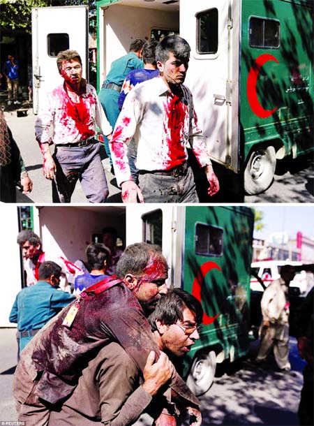 Two seriously wounded among hundreds more have been injured in a massive explosion near the British embassy in Kabul (Top) and an Afghan man carries an injured man to a hospital after the massive blast in Kabul, yesterday morning. The explosion happened a