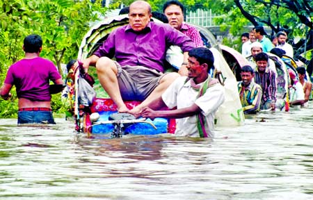 The main thoroughfares in Chittagong port city were inundated under waist deep water due to incessant rains triggered by Cyclone Mora for several hours. Only rickshaws are plying on water logging area in a desperate bid. This photo was taken from Agrabad