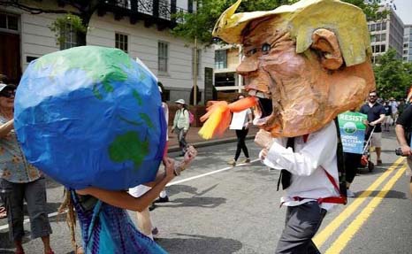 Protesters dressed as Earth and US President Donald Trump pretend to fight in Washington.