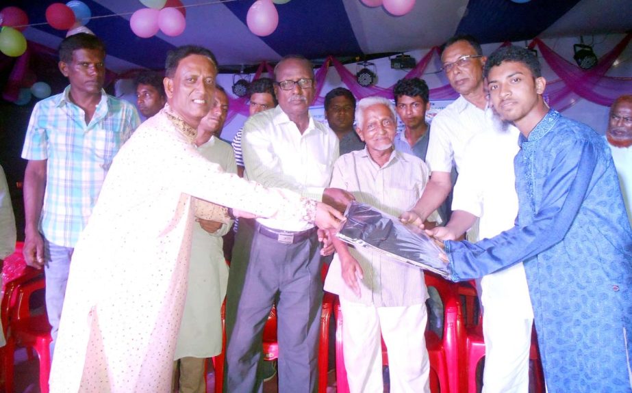 Freedom fighter Md Mohiuddin Ahmed Bhuiyan distributing prizes among the meritorious students organised by ghautola Railway Diesel Colony Samaj Kallyan Parishad recently.
