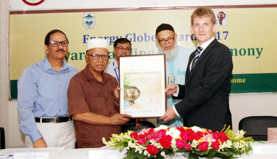 General Secretary of Dhaka Ahsania Mission (DAM), Prof Abdus Sobhan receiving Energy Globe Award from Siegfried Weidlich, Commercial Attache, Austrian Embassy in India at a ceremony held in DAM auditorium in the city on Wednesday.