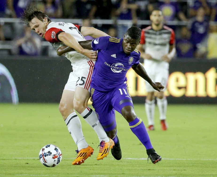 D.C. United's Jared Jeffrey (25) and Orlando City's Carlos Rivas (11) battle for possession of the ball during the first half of an MLS soccer game on Wednesday.