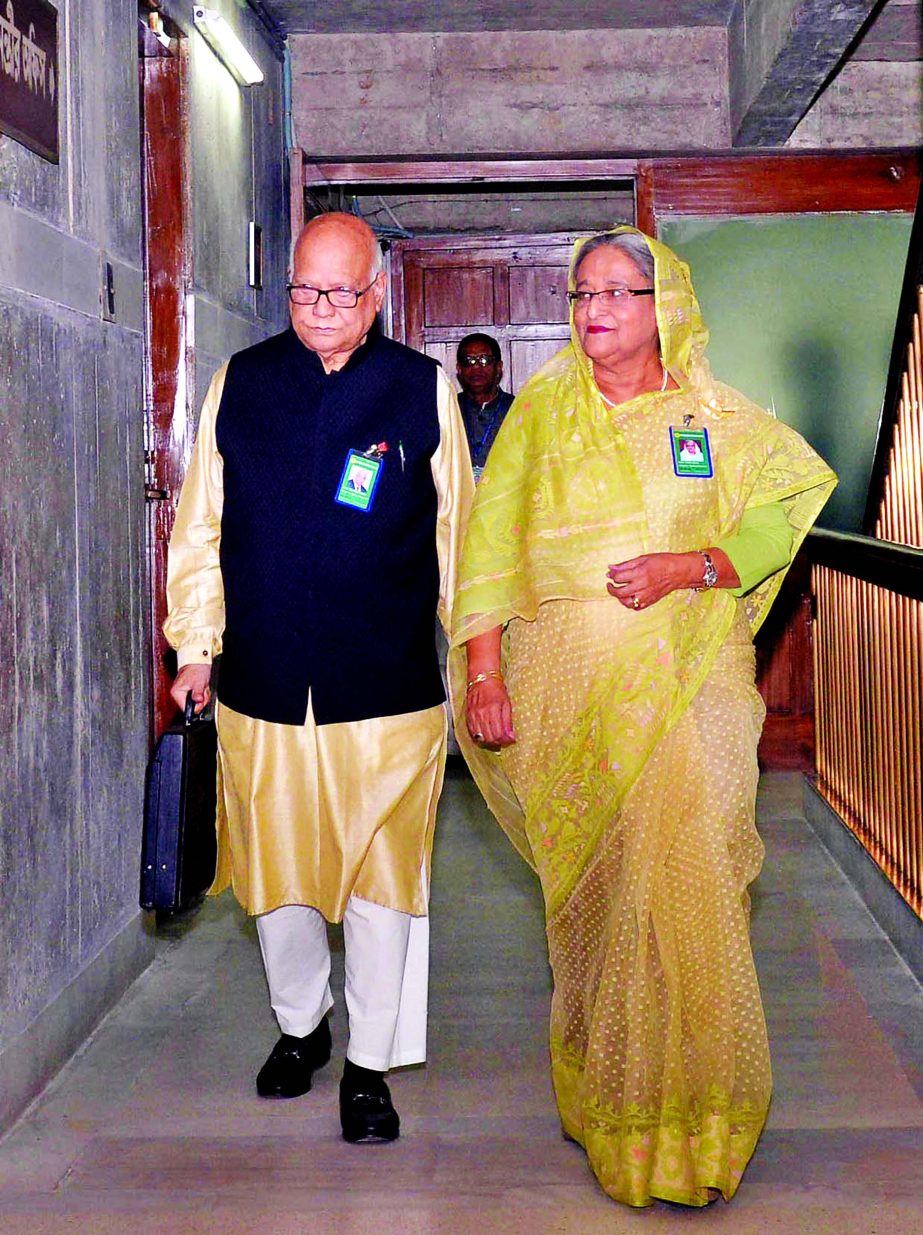 Finance Minister Abul Maal Abdul Muhith along with Prime Minister Sheikh Hasina entering the Sangsad Bhaban carrying the traditional suitcase to place the National Budget for the fiscal 2017-2018 on Thursday.