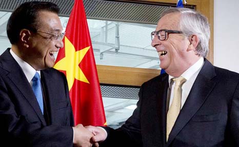 Chinese Prime Minister and Jean-Claude Juncker shake hands prior to a meeting at the European Council.