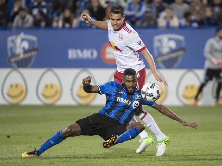 Montreal Impact forward Anthony Jackson-Hamel falls in front of New York Red Bulls midfielder Aaron Long during the second half of an MLS soccer match in Montreal on Saturday.