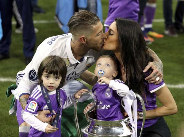Real Madrid's Sergio Ramos celebrates with his family after winning the Champions League final soccer match against Juventus at the Millennium Stadium in Cardiff, Wales on Saturday.