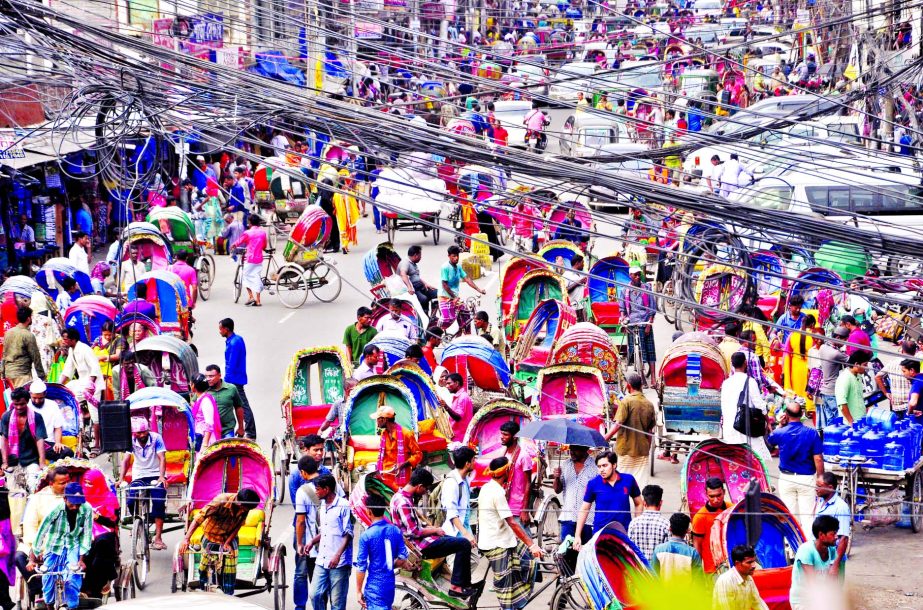 Thousands of rickshaws plying on the city streets without license creating traffic gridlock which is everyday affair. This photo was taken from city's Gawsia Market area on Sunday.