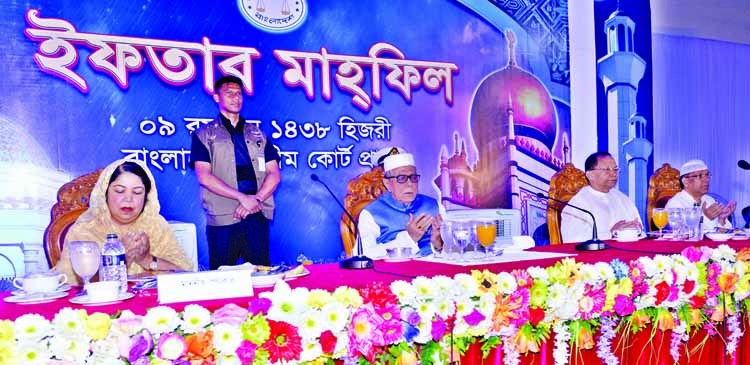 President Abdul Hamid along with other distinguished persons offering Munajat at an Iftar Mahfil organised by Bangladesh Supreme Court on its premises on Monday. Chief Justice Surendra Kumar Sinha was present on the occasion.