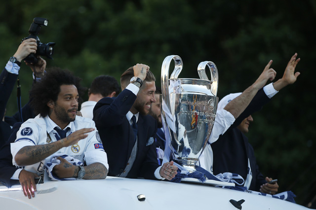 Real Madrid players arrive on an open-topped bus to Cibeles square to celebrate after winning the Champions League final, Madrid, Spain on Sunday. Real Madrid became the first team in the Champions League era to win back-to-back titles with their 4-1 vict