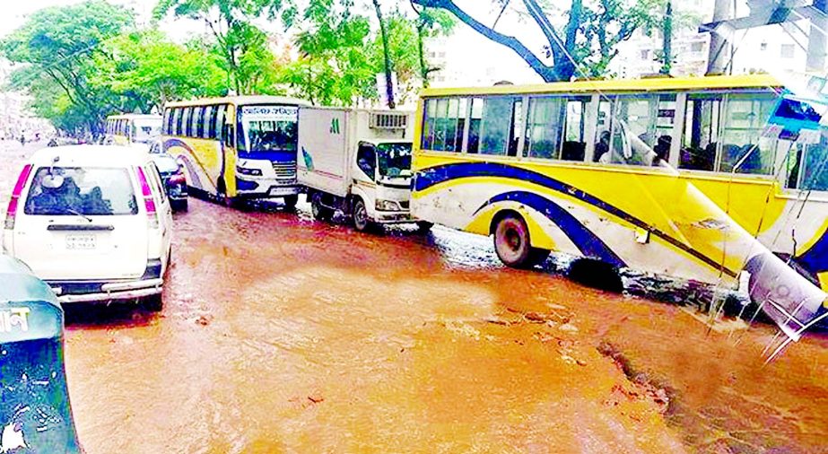 Heavy vehicles still plying the road stretches from Rampura Bridge-Demra-Amulia via Banasree in Dhaka despite entry-exit ban order for three months by the court, as this road is in a dilapidated condition. This photo was taken on Monday.