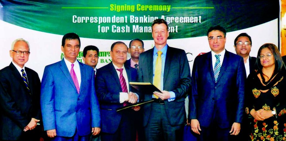 Md Abdul Halim Chowdhury, Managing Director of Pubali Bank Ltd. and Tony Menzies, Chief Operating Officer of HSBC Bank exchanging agreement singing documents on Correspondent Banking at Pubali Bank head office in the city on Tuesday. Under the deal, HSBC